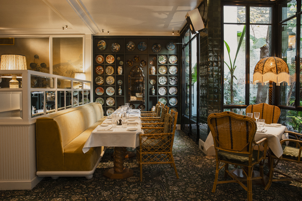 Selected restaurant interior with decorative plate wall where Veenus is served